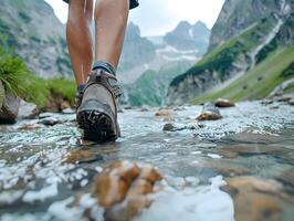 Hiking hiker traveler landscape adventure nature outdoors sport background panorama - Close up of feets with hiking shoes from a man or woman walking in the river photo