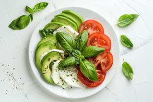 Salad with tomatoes, mozzarella, basil and allspice spices. Top view photo