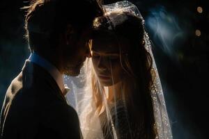 Wedding of a man and a woman. They hug and pose for a photo. Warm colors, dark background. Mysterious atmosphere photo