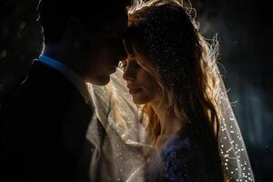 Wedding of a man and a woman. They hug and pose for a photo. Warm colors, dark background. Mysterious atmosphere photo