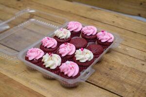 Red velvet cupcakes in plastic tray ready to be decorated. photo