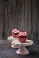 Cupcakes on small ceramic plate with wooden bottom with copy space. Product photo. photo