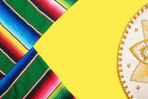 Mariachi hat and serape on yellow background. Mexican independence concept. Cinco de mayo background. photo