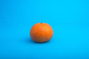 Mandarin isolated on blue background. photo