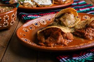 Gorditas de chicharron in green sauce and red sauce. Mexican food. photo