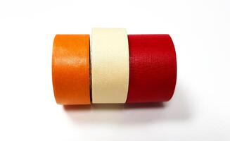 Three masking tapes roll red, white, and orange isolated on white background. Object for stick on paper. photo