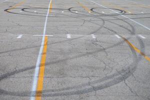 looping car tracks in the middle of a parking lot photo