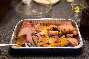 roasted ham in a pan all ready for serving at a family gathering photo