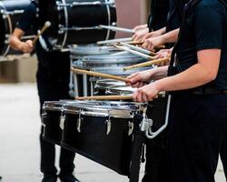 section of a marching band drum line warming up for a parade photo