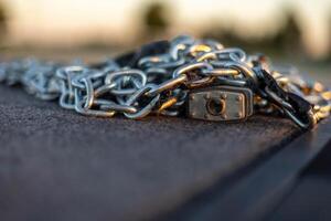 a pile of chains and a padlock used to secure a drum majors stand photo