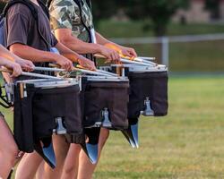 a section of a marching band drum line rehearsing photo