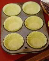 a tray of cupcake papers waiting for vegetarian cornbread batter to be spooned in photo