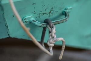 rope attached to a metal handle that is screwed into a rowboat photo