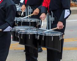 snare section of a marching band drum line warming up for a parade photo