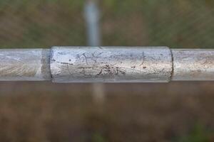 a repaired section of hand railing on the front section of some bleachers photo