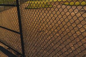 the infield of a baseball diamond in the early morning photo