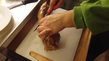 video of the cutting of a stuffed and baked pork leg photo