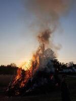 A bonfire burns dangerously in a field photo