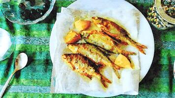 watercolorstyle representing a plate of small fried fish with lemon ready to serve photo