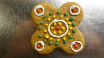 Ginger cookie in the shape of a colorful four leaf clover photo