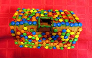 a home-made gingerbread house with the roof covered with chocolates photo