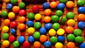 Small colorful chocolates on the roof of a homemade gingerbread house photo