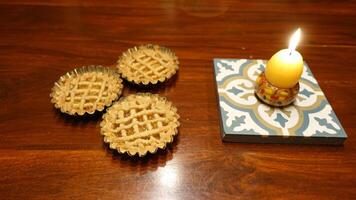 Traditional Easter cakes and a lit egg-shaped candle to wish everyone a happy Easter photo