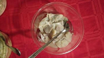 video of bowls of herring in mustard, cream and dill sauce photo