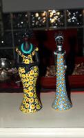 dos pequeño estatuas de africano mujer con vistoso ropa foto