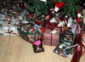 Christmas parcels and gift packages placed under the Christmas tree photo