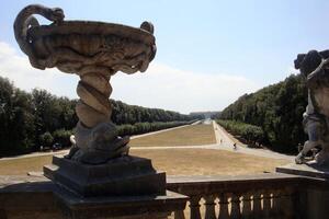 Caserta, Italy, Europe - July 10, 2019 statue and perspective of the royal palace avenue photo