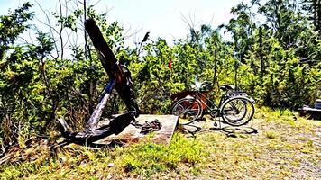 Digital painting style representing two bicycles parked near a large ancient anchor photo