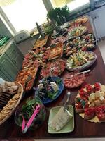 A table set with trays and mixed dishes ready for the buffet photo