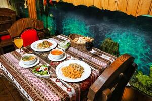 Table With Food Plates Next to a Painting photo