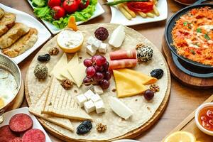 Assorted Cheeses and Meats Spread on a Table photo