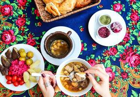 Table With Assorted Food Plates and Soup Bowls photo