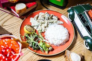 Plate of Food on Table Next to Toy Car photo