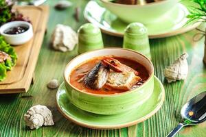 Green Table With a Bowl of Soup photo