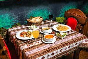 Table Set With Assorted Food Plates and Soup Bowls photo