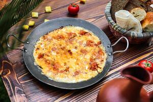 Pizza on Pan on Wooden Table photo