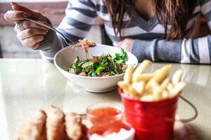 Woman Sitting at Table With Bowl of Food photo