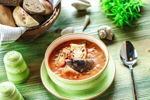 Green Plate With Bowl of Soup photo