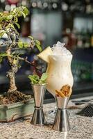 Small Bonsai Tree Next to Two Cocktail Glasses photo