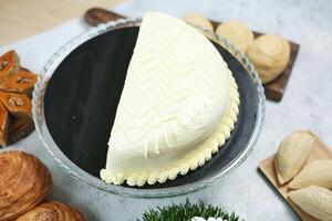 Cake Sitting on Table Alongside Croissants photo