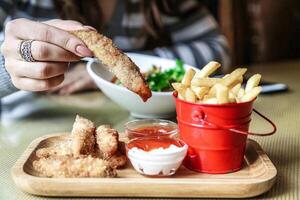 Person Holding Bread Over Plate of Food photo