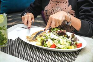 Woman Sitting at Table With Plate of Food photo