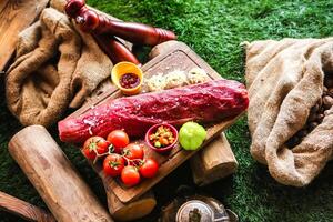 Fresh Raw Meat With Vegetables and Spices on Cutting Board photo