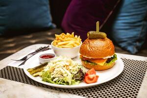 Delicious Burger and French Fries Plated Meal photo