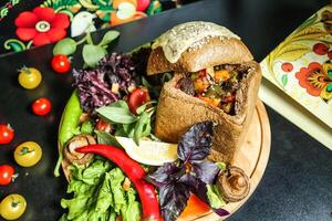 Wooden Plate With Sandwich and Salad photo