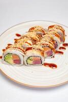 Delicious Sushi Plate Topped With Flavorful Sauce photo